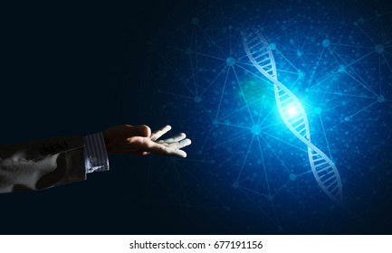 Close of businessman hand presenting DNA molecule research as concept. Mixed media - Shutterstock ID 677191156