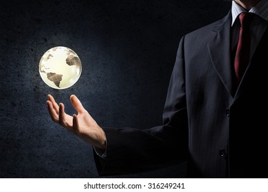 Close Up Of Businessman Hand Showing Digital Earth Globe