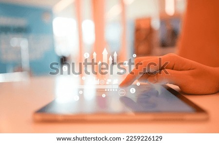 close up businessman hand touch screen on digital tablet to use marketing tool and check traffic research of pay per click program on web page for online b2b business and lifestyle concept
