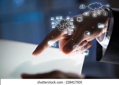 Close up of businessman hand touching tablet screen - Shutterstock ID 228417505