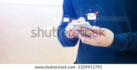 close up businessman hand touchscreen on smartphone devices for received unread e-mail listing or sending mail to partner and customer , virtual interface technology concept