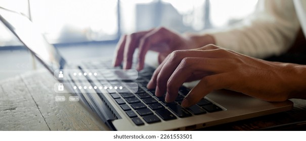 close up businessman hand type on laptop keyboard to access account on website by input username and password at office for security system of business technology concept