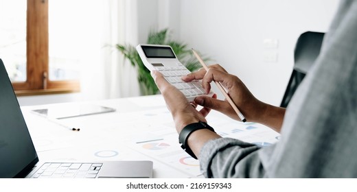 Close up businessman hand using calculator and working with laptop calculate about finance accounting at coffeeshop outdor.finance accounting concept
