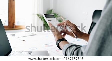Close up businessman hand using calculator and working with laptop calculate about finance accounting at coffeeshop outdor.finance accounting concept
