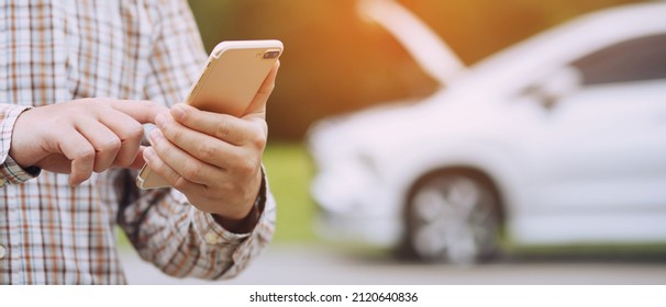 close up businessman hand using a mobile smart phone call a car mechanic ask for help assistance because car broken roadside. people journey friends standing wait beside broken car background. - Powered by Shutterstock