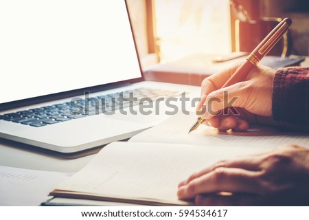 Close up businessman hand writing working with modern computer 