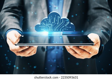 Close up of businessman hands holding tablet with abstract digital cloud circuit on blue background. Cloud computing, server and integrated digital web concept - Powered by Shutterstock