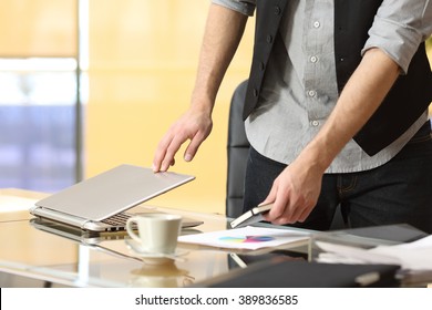 Close Up Of A Businessman Hands Leaving Work And Closing Laptop At Office