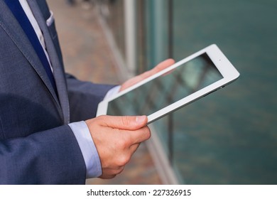 Close up of businessman hands with tablet pc. Copy space. - Shutterstock ID 227326915