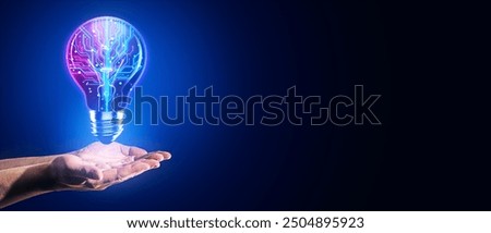 Close up of businessman hands using creative glowing blue circuit light bulb on wide dark blue background with mock up place. Artificial intelligence, knowledge and innovation concept