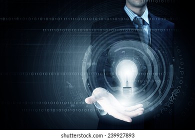 Close up of businessman holding bulb in palm - Powered by Shutterstock