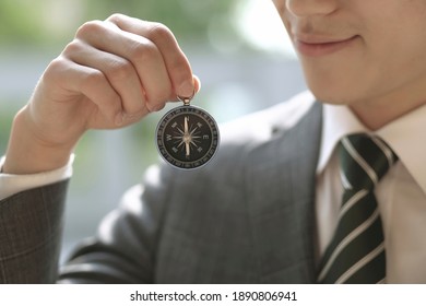 Close up of businessman holding Compass
