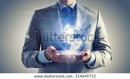 Close up of businessman holding digital globe in palm