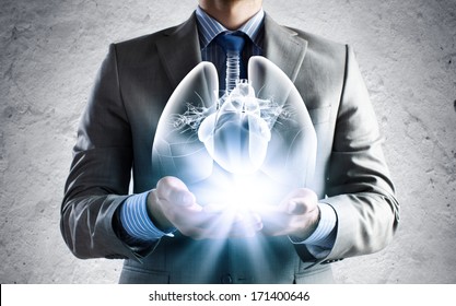 Close Up Of Businessman Holding Image Of Lungs In Hands