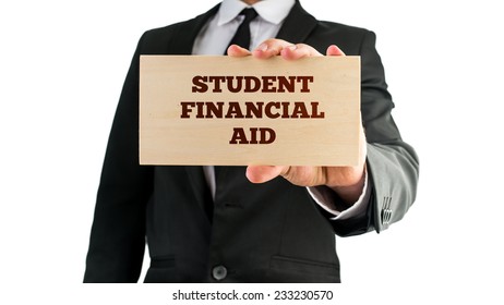 Close Up Of Businessman Holding A Rectangular Wooden Sign Saying Student Financial Aid. Isolated On White Background.