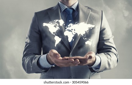 Close up of businessman holding world map in hands