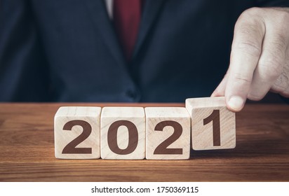 A Close Up Of A Businessman Looking Ahead To The Future With Confidence And Changing The Date Of A Calendar To 2021