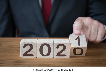 A Close Up Of A Businessman Looking Ahead To The Future With Confidence And Changing The Date Of A Calendar To 2021