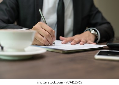 Close up businessman is signing a contract, business contract details at coffee shop - Shutterstock ID 789412765