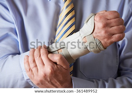 Close Up Of Businessman Suffering With Repetitive Strain Injury (RSI)