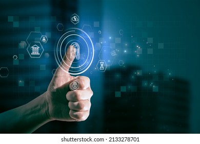 Close up of businessman thumb pointing at abstract glowing id fingerprint web protection and security interface on blurry blue bokeh city background. Identification, cybersecurity and privacy concept.