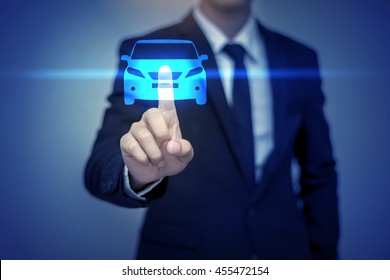 Close up of businessman touching car icon on virtual screen