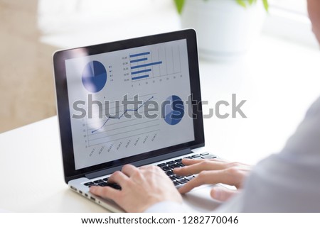 Close up businessman using laptop, analyze business statistics, look at screen, presentation with graphs and diagrams, writing financial report, project management, accounting, market research
