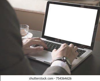 Close Up Of Businessman Using A Laptop With White Screen On The Desk.