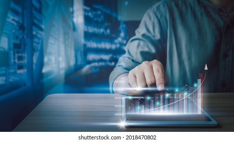 Close Up Businessman Using Tablet For Checking Business Growth Up Or Stock Market With Data Statistics Level Up Of Graph Or Chart.Financial  Technology Concept,planning And Strategy.Gas Oil Industrial