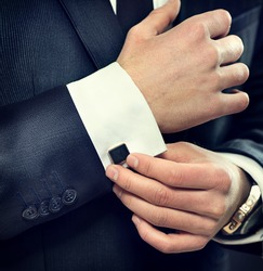 Close Up Of Businessman Wearing Cufflinks. Elegant Young Fashion Business Man Wearing Suit