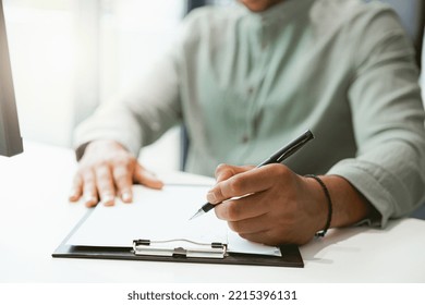 Close up of businessman working with documents while sitting in office - Shutterstock ID 2215396131
