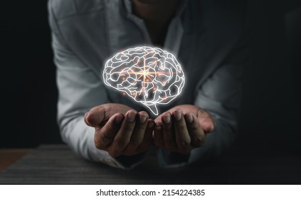 Close up of businessman's hand holding the brain in the palm, Virtual reality man with symbol neurons in the brain. Concept of idea and innovation, copy space. - Shutterstock ID 2154224385