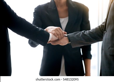 Close up of businesspeople pile hands, close links between business, trade fairly with suppliers, business ventures, exploring new opportunities, approved apply for a loan to start a business concept