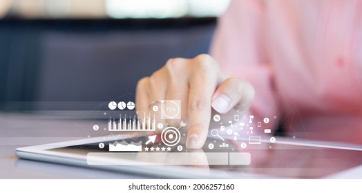close up businesswoman hand touch screen on digital tablet to use marketing tool and check traffic research of pay per click program on web page for online b2b business and lifestyle concept - Shutterstock ID 2006257160