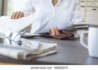 Close Up Of A Businesswoman Hands Leaving Work And Closing Laptop At Office