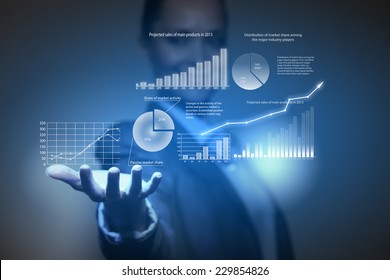 Close up of businesswoman holding graphs in hand