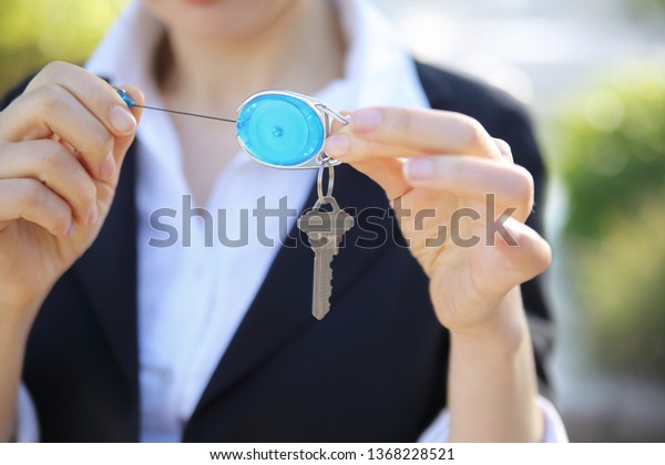 Close up of
businesswoman holding key ring and
key