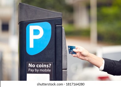 Close Up Of Businesswoman Making Contactless Payment For Car Parking At Machine With Card