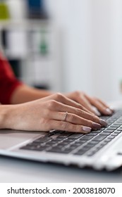 Close up of businesswoman manager hands fingers typing documents on laptop keypad. Detail shot of etrepreneur pressing on keyboard with fingers. Laptop receiving imput from