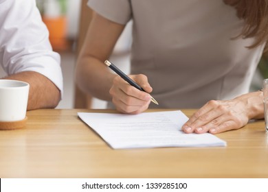 Close up businesswoman signing contract with business partner, new employee hiring process, client putting signature on legal document, taking loan or purchase property, successful deal - Shutterstock ID 1339285100