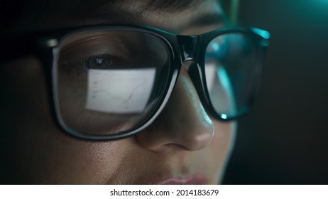 Close Up Of Businesswoman Wearing Eye Glasses Looking At Pc Screen With Computer Reflection Using Internet, Reading, Watching, Studying Online, Working Online. 