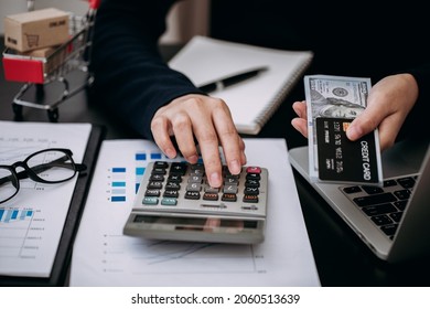 Close Up Of Businesswomen Using Calculator Calculating For Monthly Expenses And Paying Off Credit Card Debt, Accounting And Financial Planning Concept.