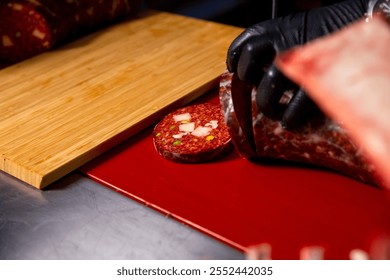 Close up Butcher handscutting sausages in a butcher shop, preparing meat products for sale. Cook cuts pieces of homemade meat products. - Powered by Shutterstock