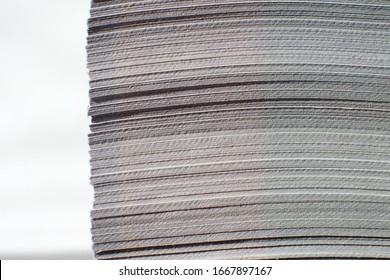 close up butt ends stack of sheets, side view