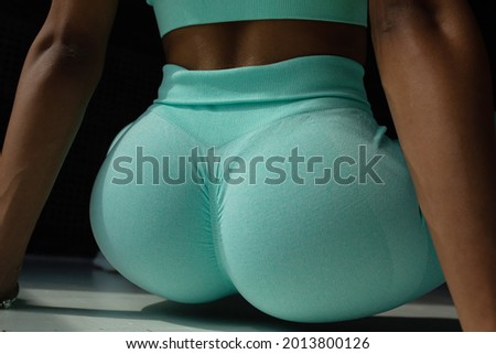 close up of buttocks fitness woman in sportswear. Home fitness workout. Female athletic glutes and legs close up.