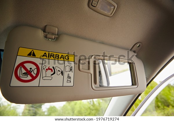 Close up of cabin car\
ceiling lamp, light control panel inside interior. Sun visor with\
mirror in a car