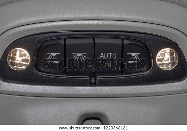 Close up of cabin lights switch in my car,\
light control panel inside a car\
interior