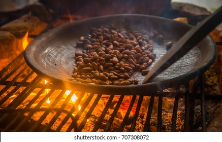 Close Up Of Cacao Bean Inside Of A Metallic Tray, Over A Wood Stove, Roasting Cocoa Beans
