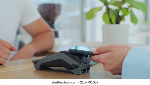 Close Up In The Cafe Man Makes Coffee For A Customer Who Pays By Contactless Mobile Phone To Credit Card System In Cafe With Digital Transaction Service.