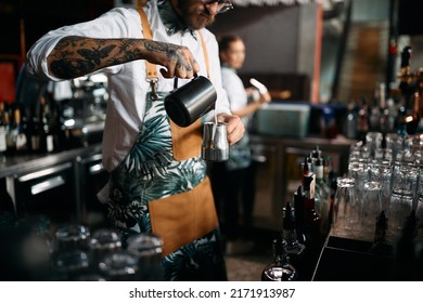 Close Up Of Cafeteria Worker Using Milk While Making Hot Drink At Bar Counter.